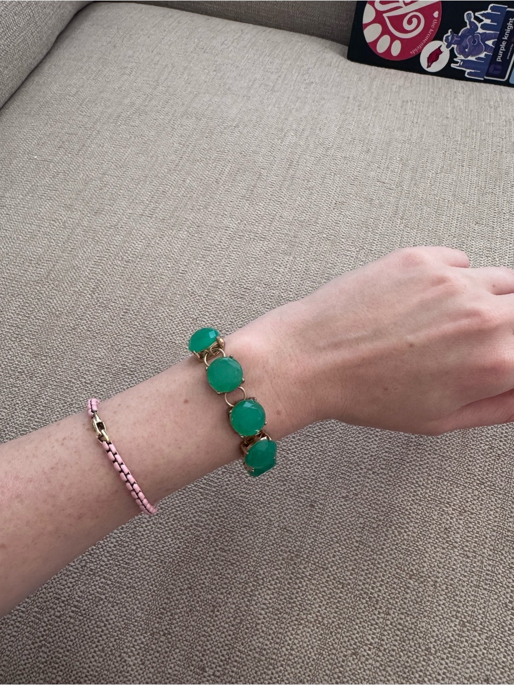 Gold link bracelet with green gemstones